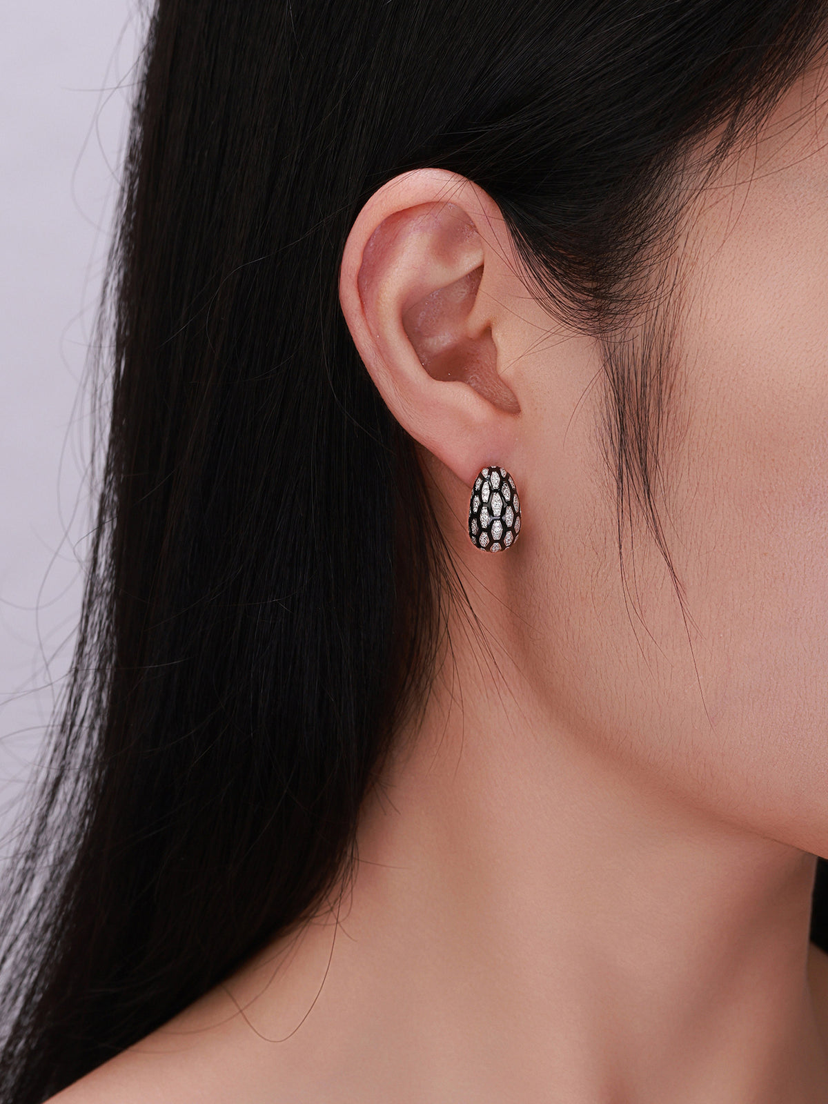 Écaille pavé diamond dome earring close-up on model