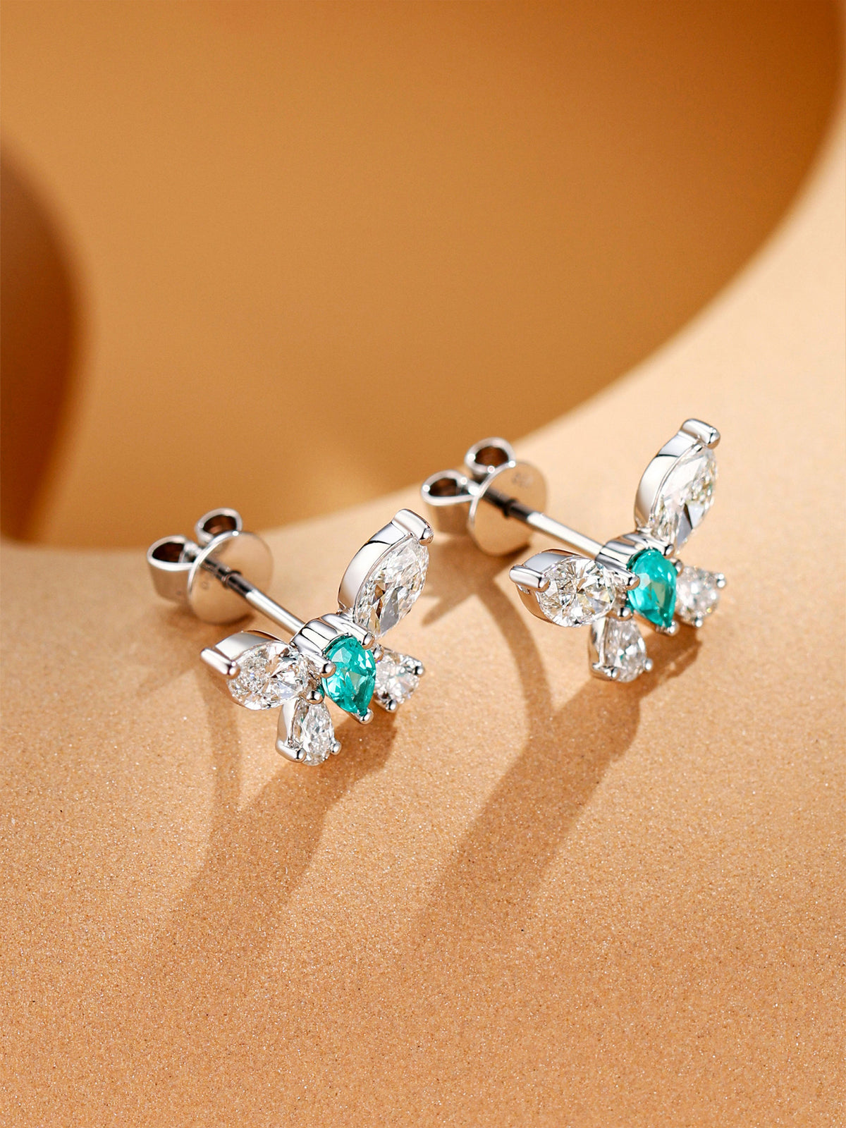 Side view of Éclair butterfly stud earrings showing claw settings and butterfly backs