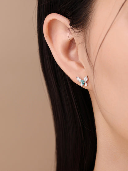 Éclair butterfly diamond stud earring worn on the ear, close-up