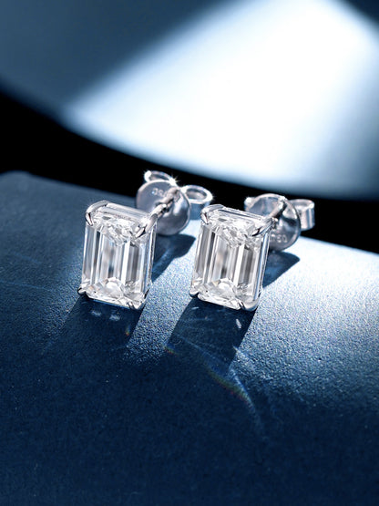 Pair of emerald-cut lab-grown diamond solitaire studs on blue suede