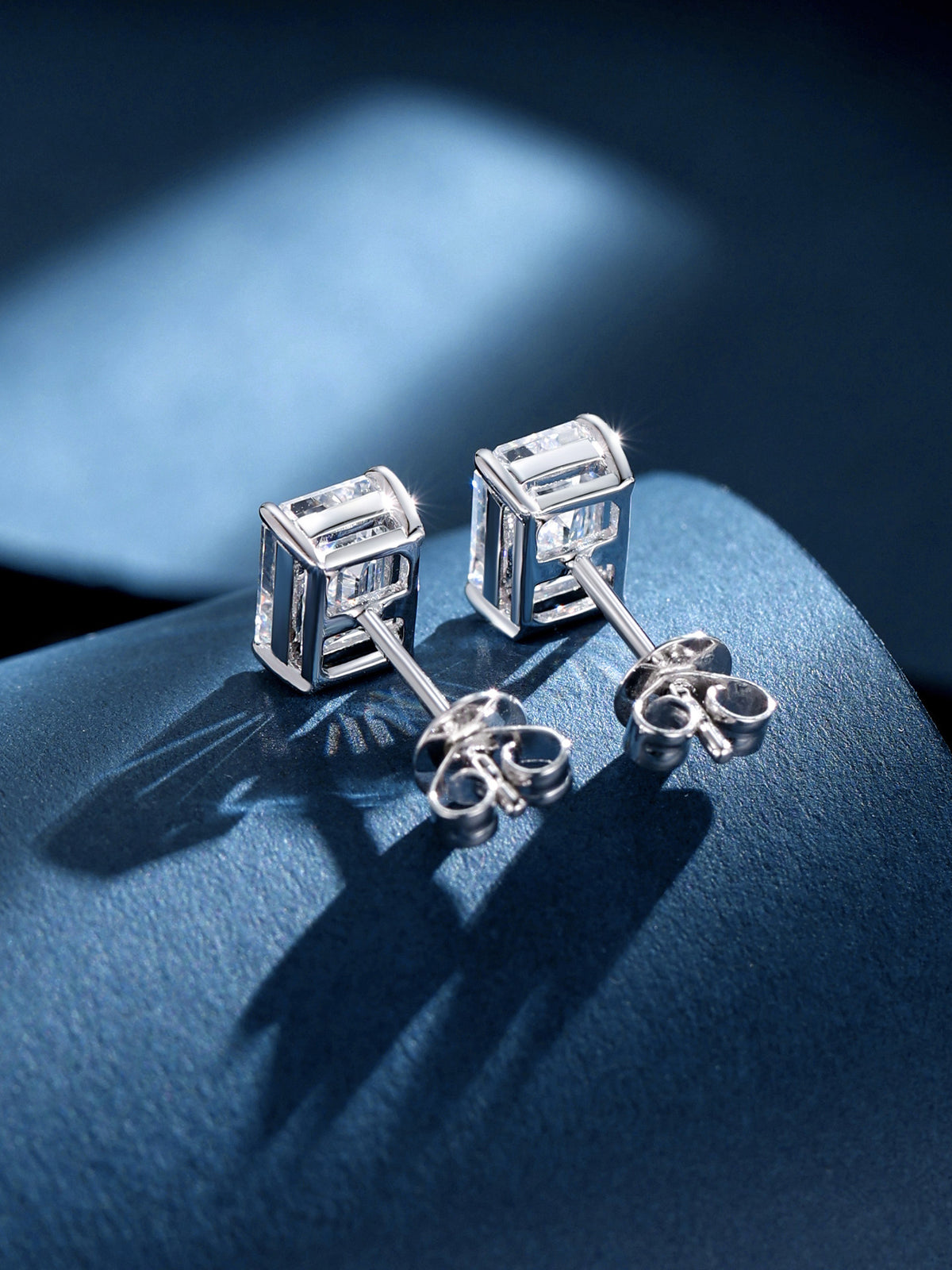 Back of the 18K white gold emerald-cut diamond studs with open gallery and butterfly backs