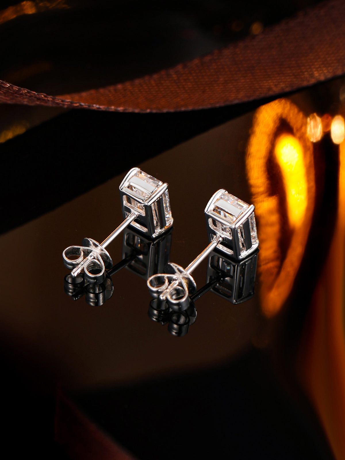18K white gold emerald-cut diamond stud earrings, back view with butterfly clutches