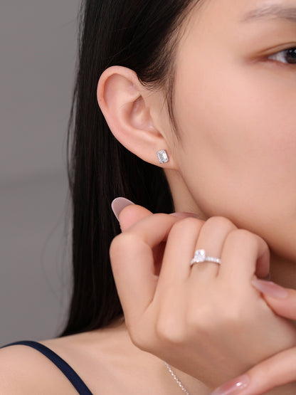 Emerald-cut diamond solitaire stud worn on the ear with a diamond ring