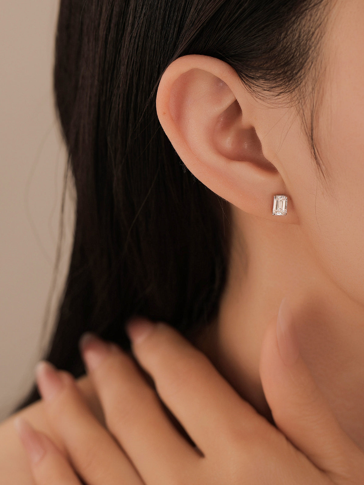 Close-up of the emerald-cut lab-grown diamond stud on the earlobe