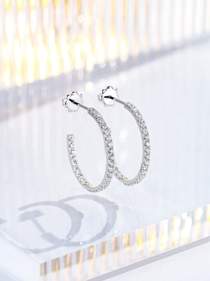 Pair of 20mm 18K white gold diamond hoop earrings with flower-shaped push backs on acrylic