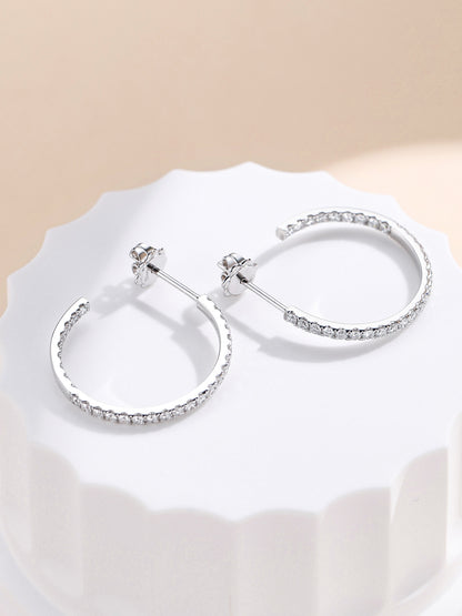Side view of the diamond hoop earrings showing the post and 18K hallmarked push back