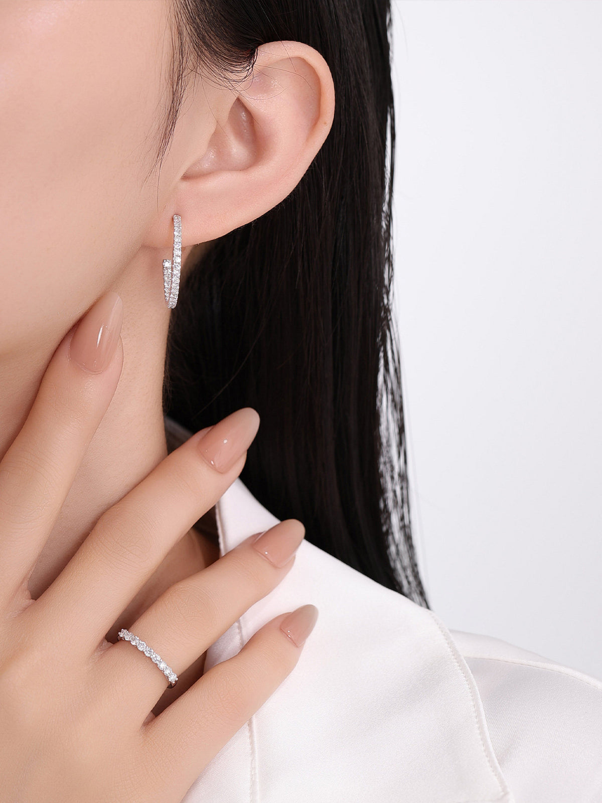 Inside-out diamond hoop earring worn with a lab-grown diamond band