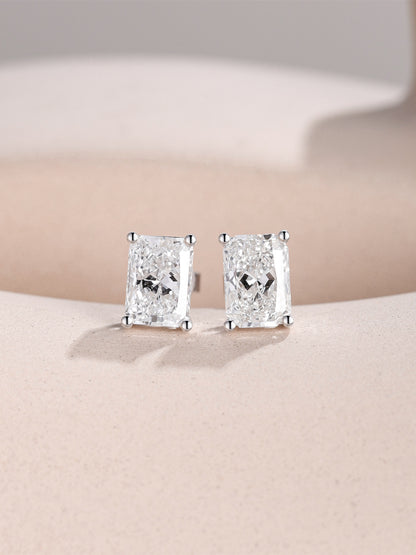 1 carat radiant-cut lab-grown diamond studs in 18K white gold on a sand-toned stone