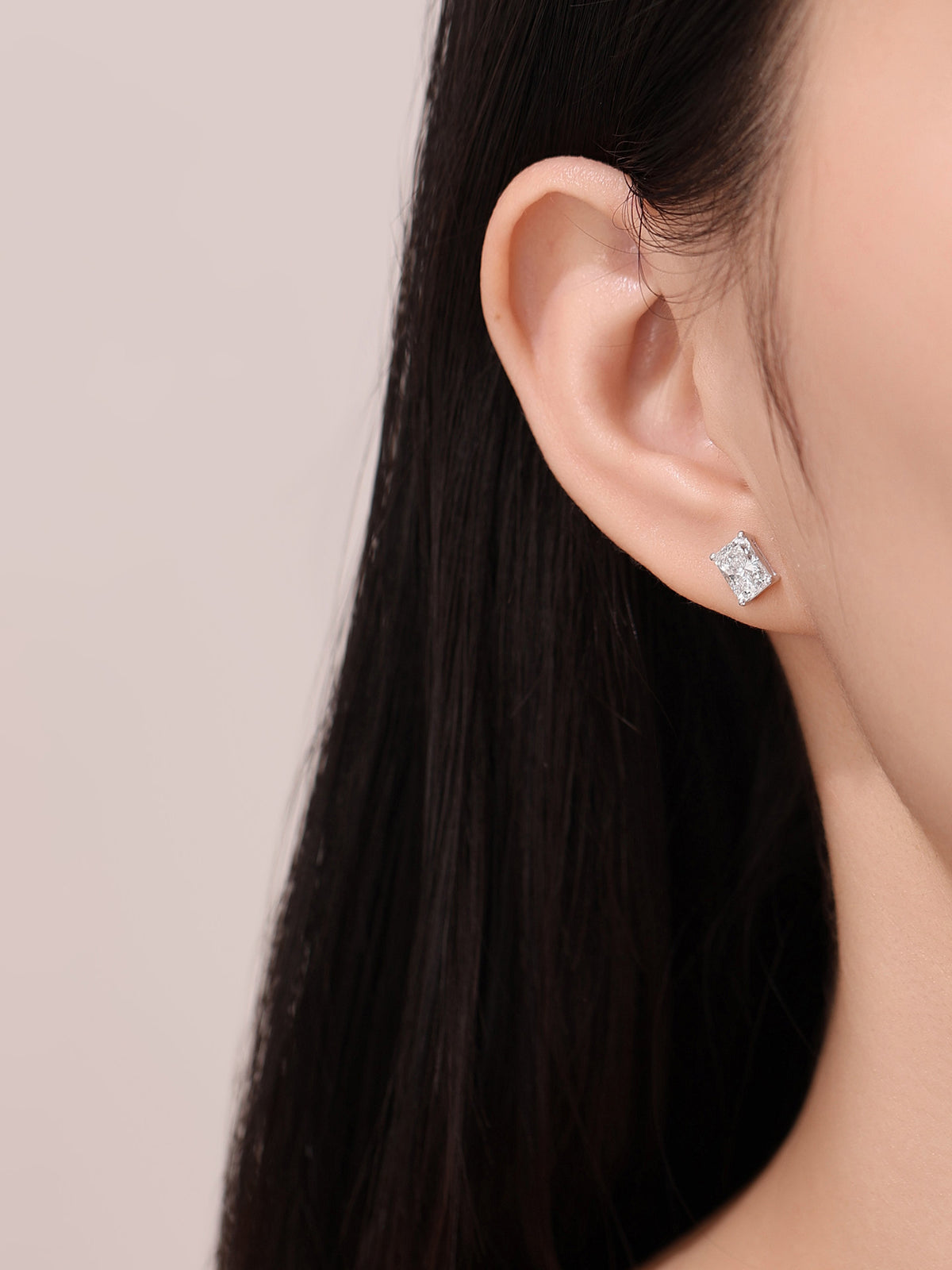 Model wearing the radiant-cut lab-grown diamond stud earring in 18K white gold