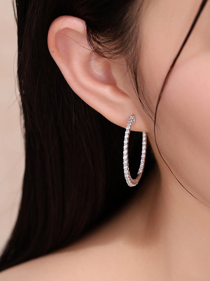 Lab-grown diamond hoop earring on the ear, side view