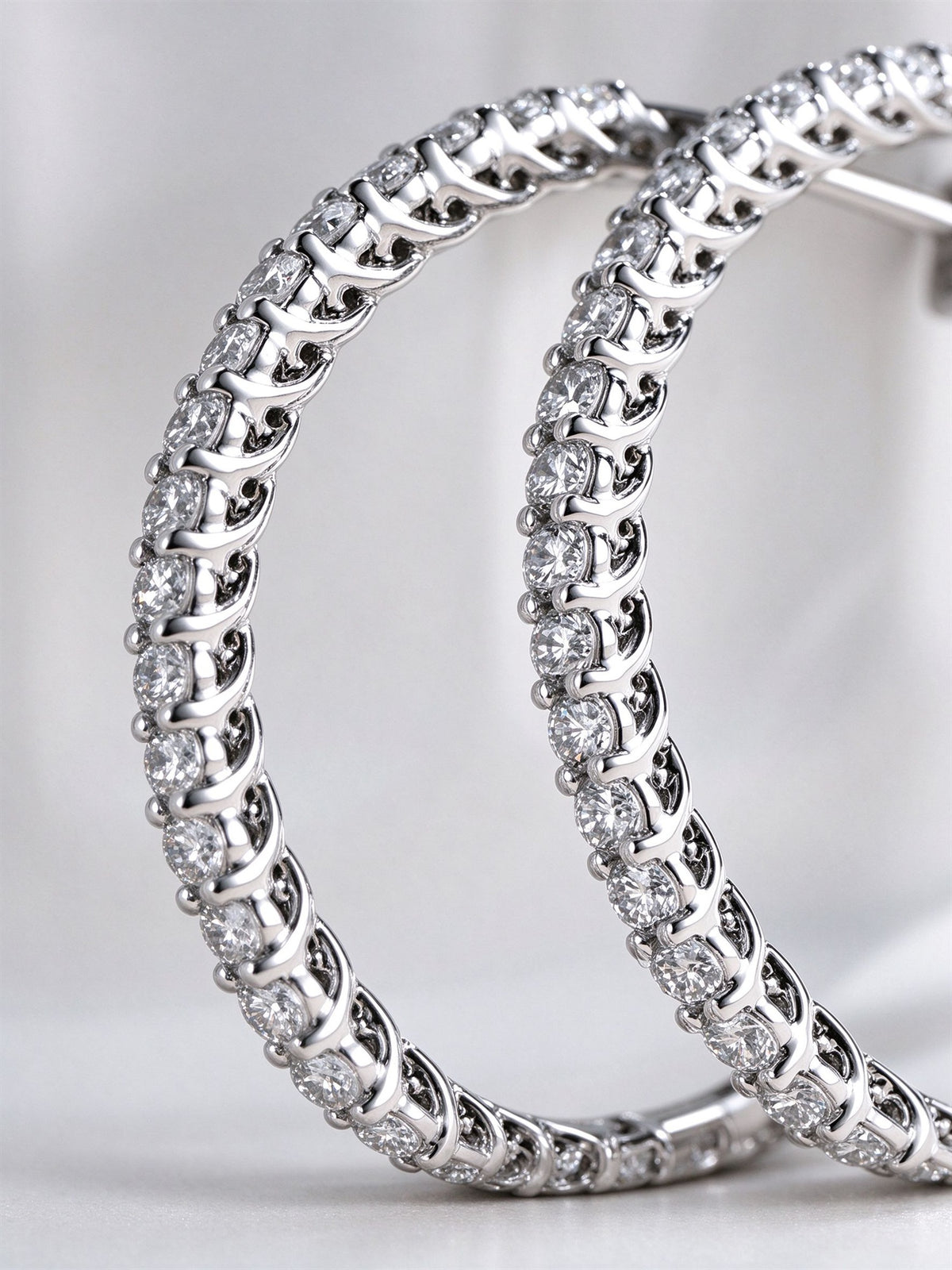 Close-up of shared-claw set lab-grown diamonds on the hoop