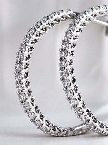 Close-up of shared-claw set lab-grown diamonds on the hoop