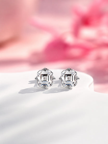 Pair of 2 carat total Asscher-cut diamond stud earrings in white gold against soft pink blossoms