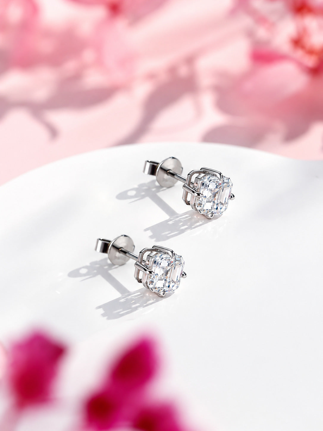 Asscher-cut lab-grown diamond studs in 18K white gold with gold butterfly backs, angled view