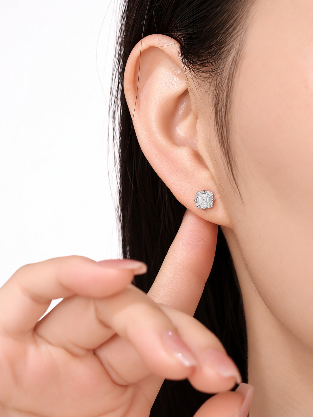 Close-up of the Asscher-cut diamond stud on the earlobe