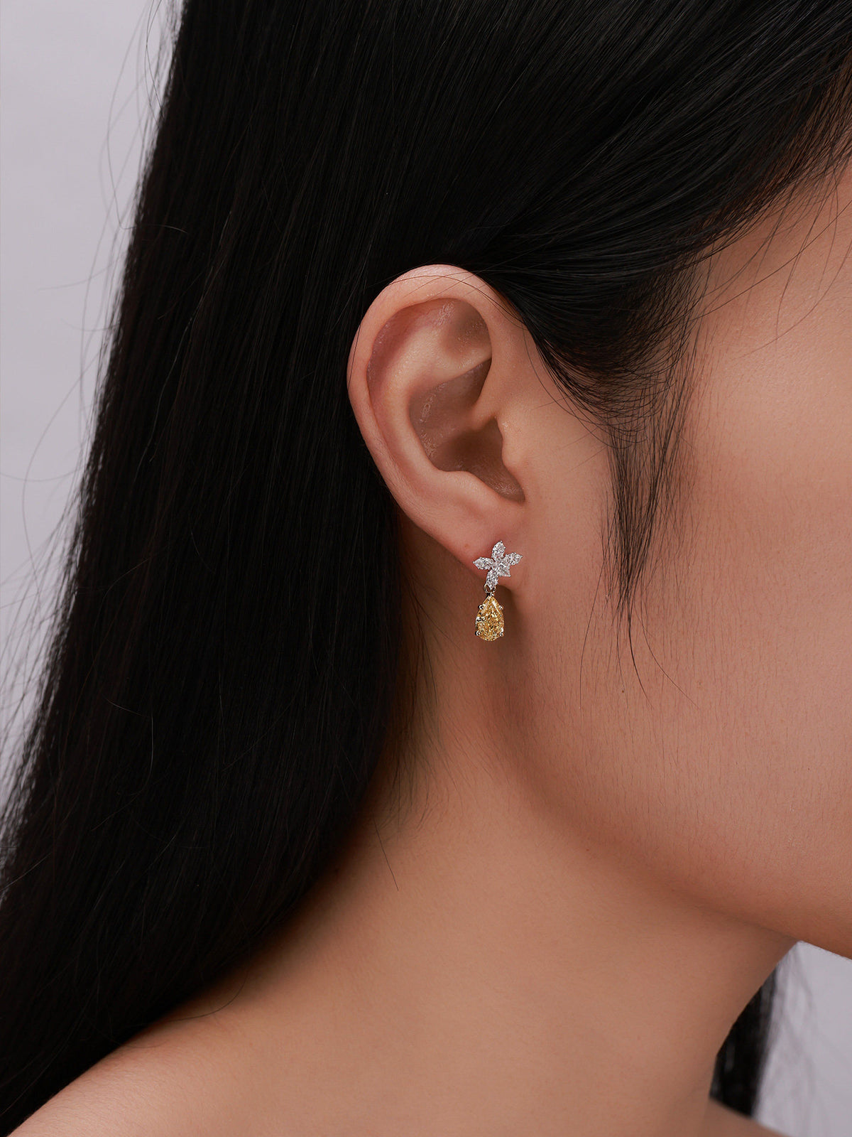 Floraison yellow diamond drop earring worn on the ear