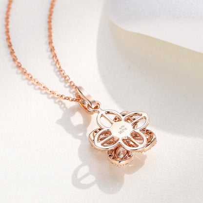 Back of the Kaleidoscope clover pendant showing the openwork spinning flower and Au750 hallmark