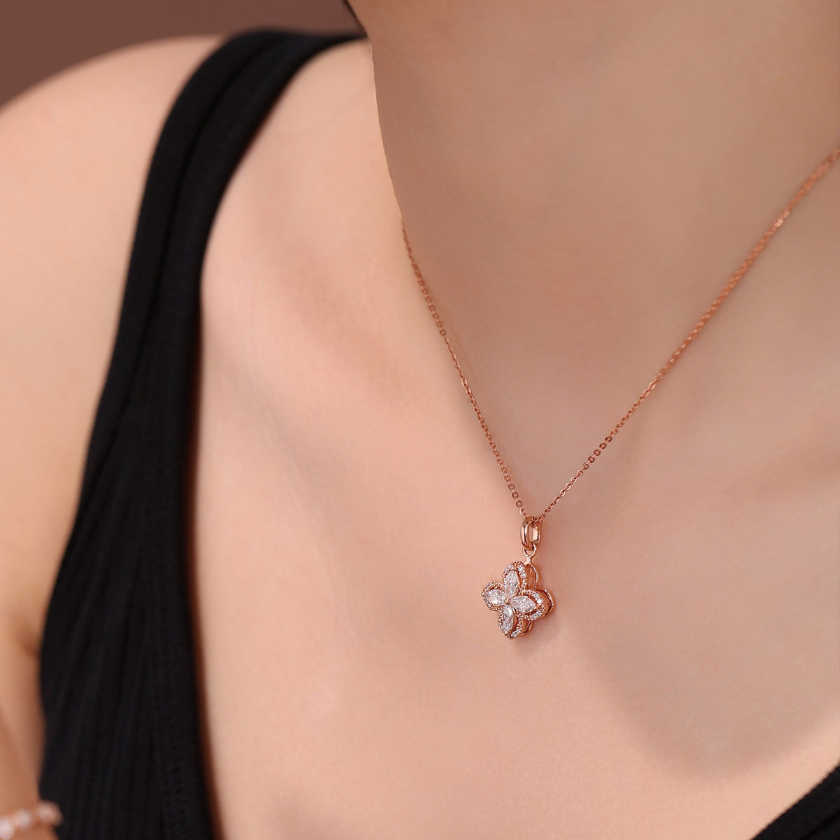Side view of the Kaleidoscope clover lab-grown diamond pendant worn on the neckline