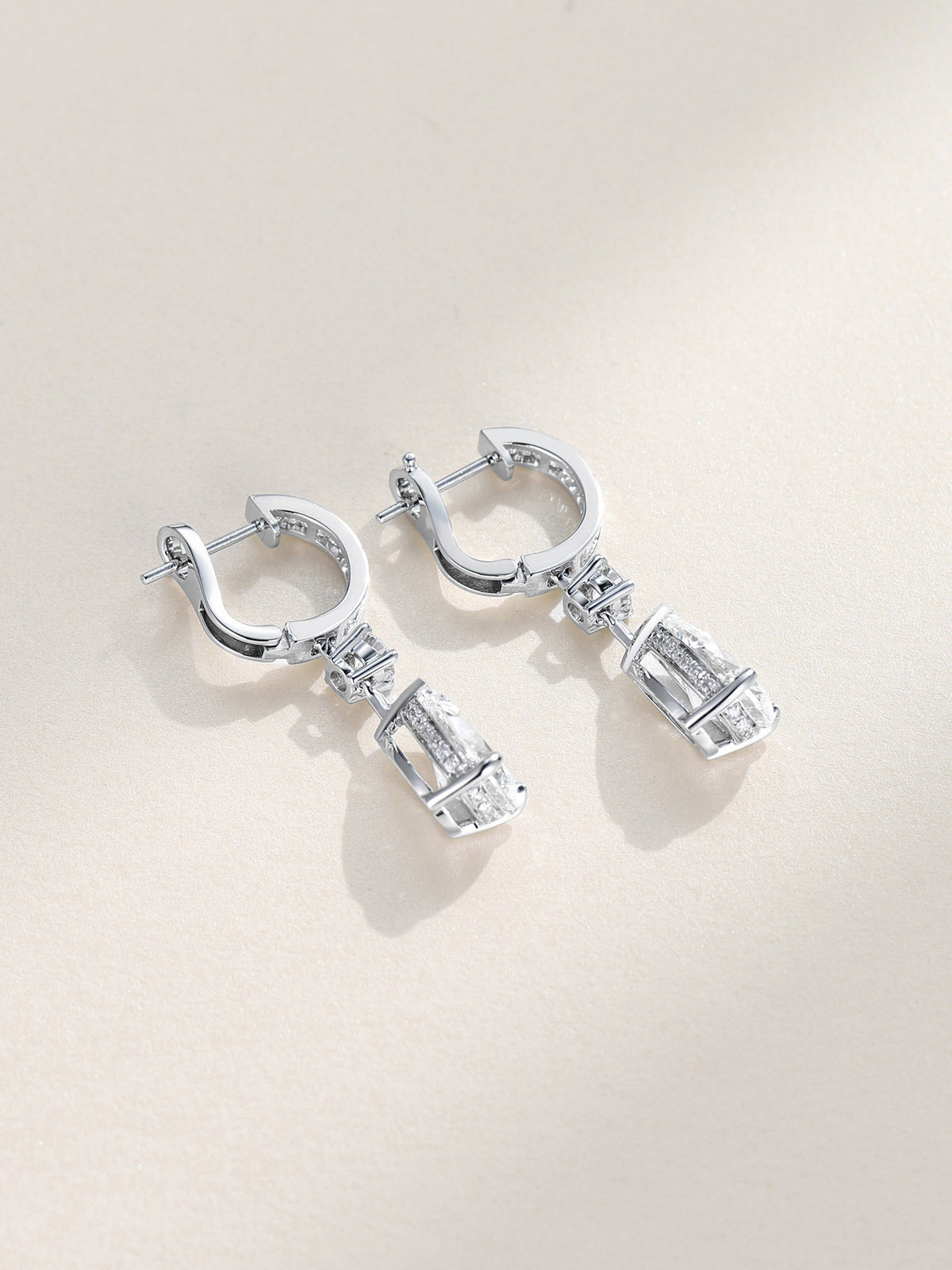 Back view of the 18K white gold diamond drop earrings showing the omega clip and pavé gallery