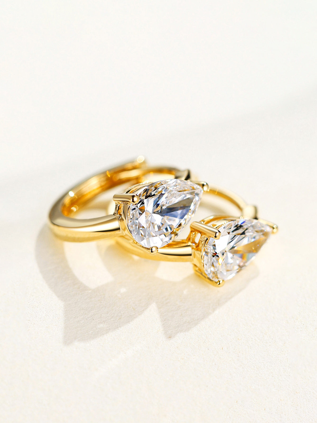 Pear-cut lab-grown diamond huggie earrings in 18K yellow gold, detail view