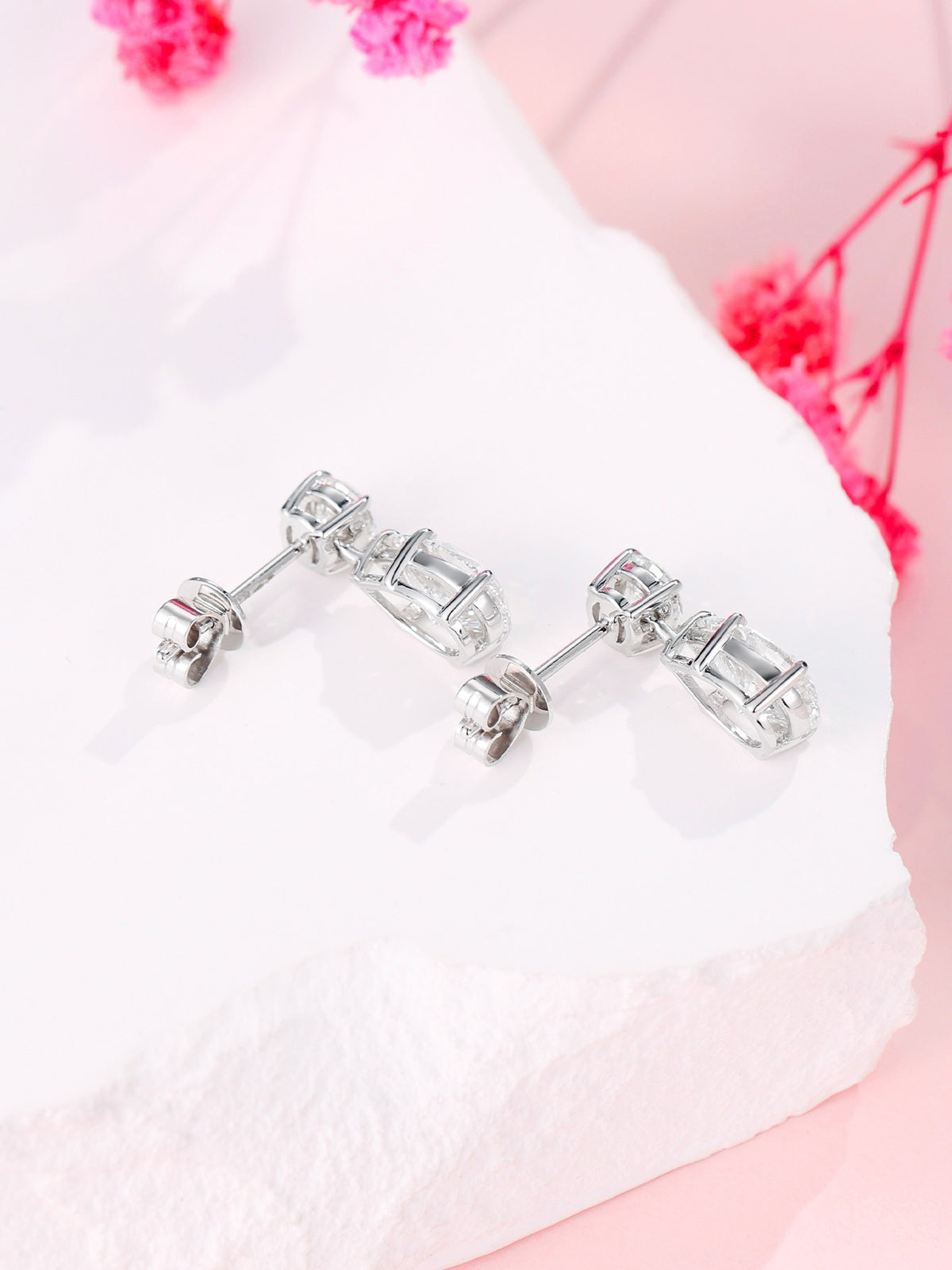 Back view of 18K gold claw settings and push-back butterfly closures