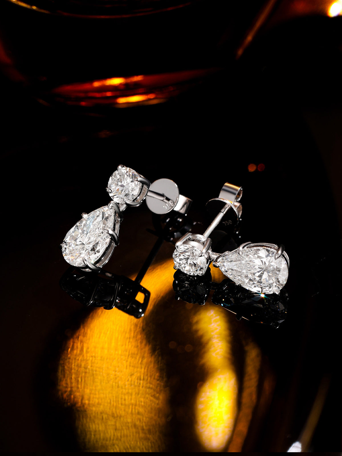 Larme diamond drop earrings showing 750 18K gold hallmark on the post