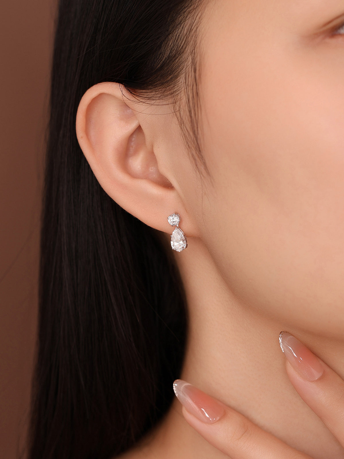 Close-up of 2 carat lab-grown diamond drop earrings on the ear