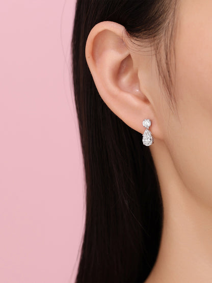 Side profile of DANFÉE Larme pear diamond drop earrings on model
