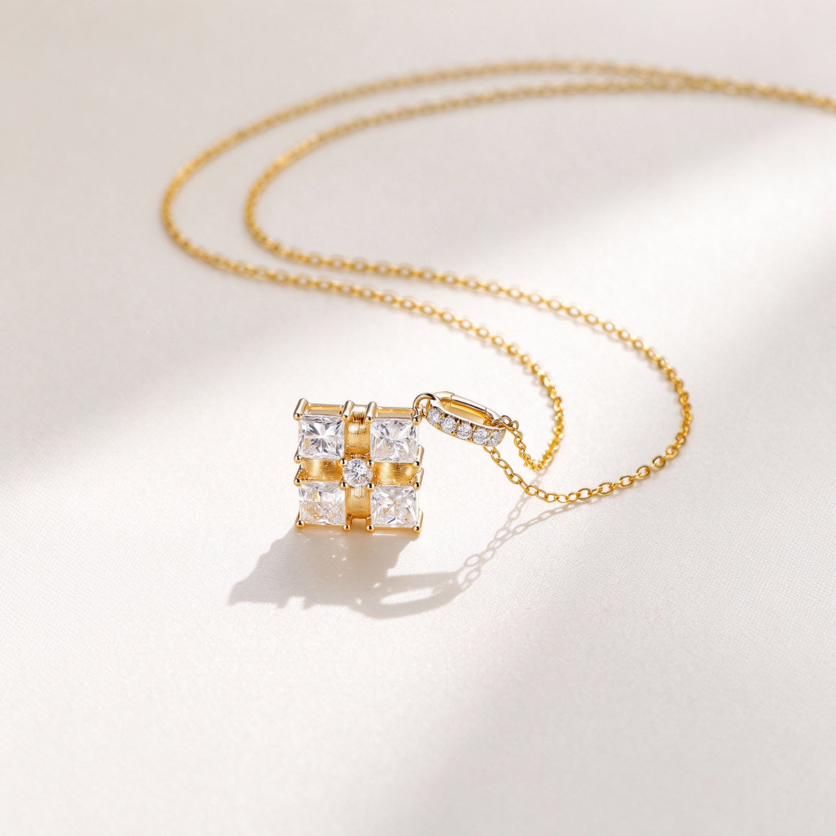 Ribbon Box diamond necklace resting on ivory fabric