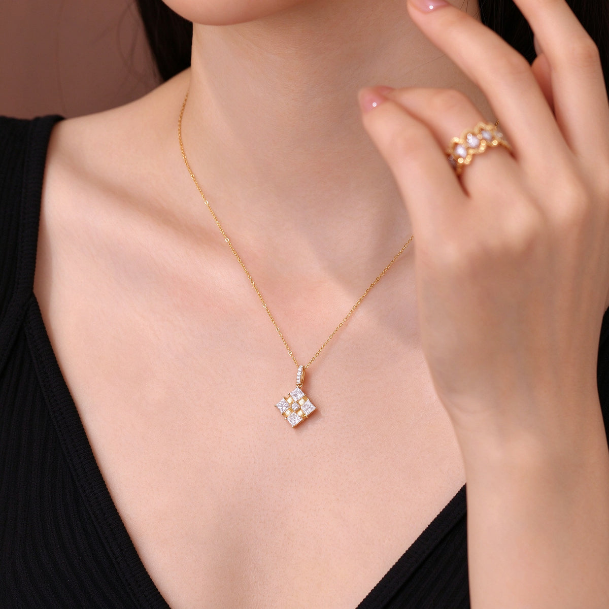 Close-up of the Ribbon Box diamond pendant worn on the neck