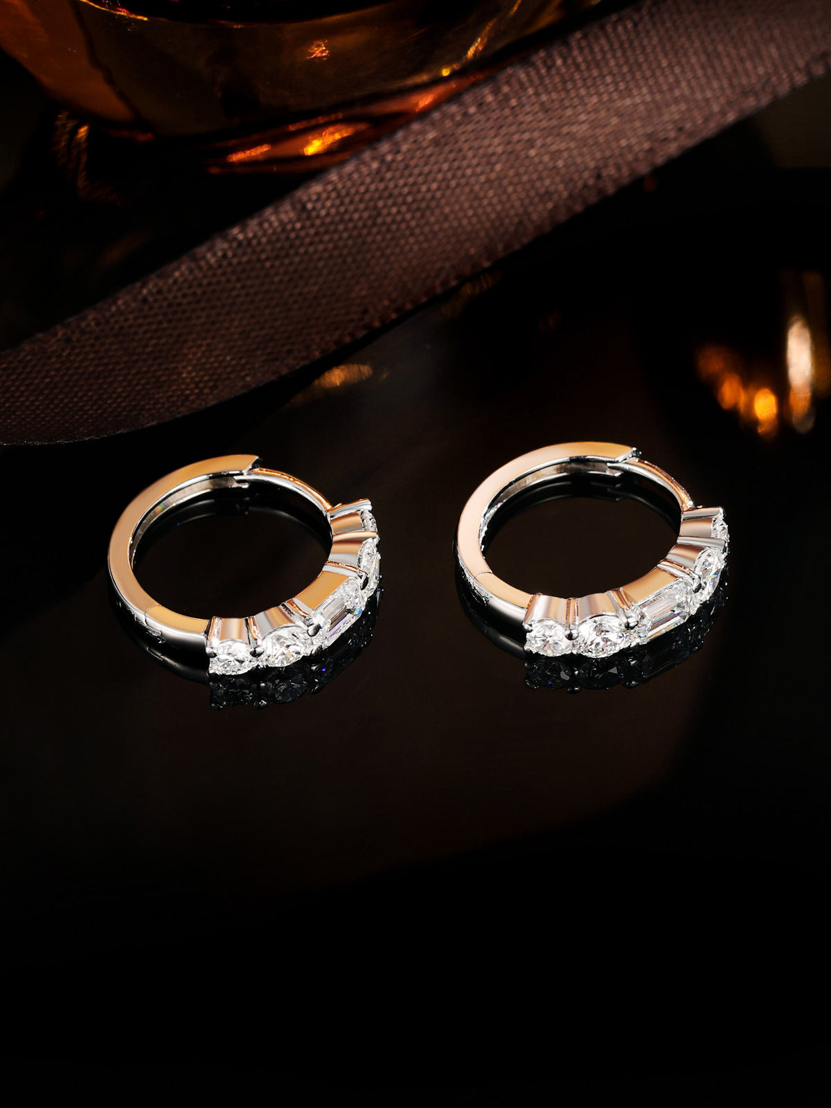 PT950 platinum huggie hoop earrings set with a row of emerald-cut and round lab-grown diamonds