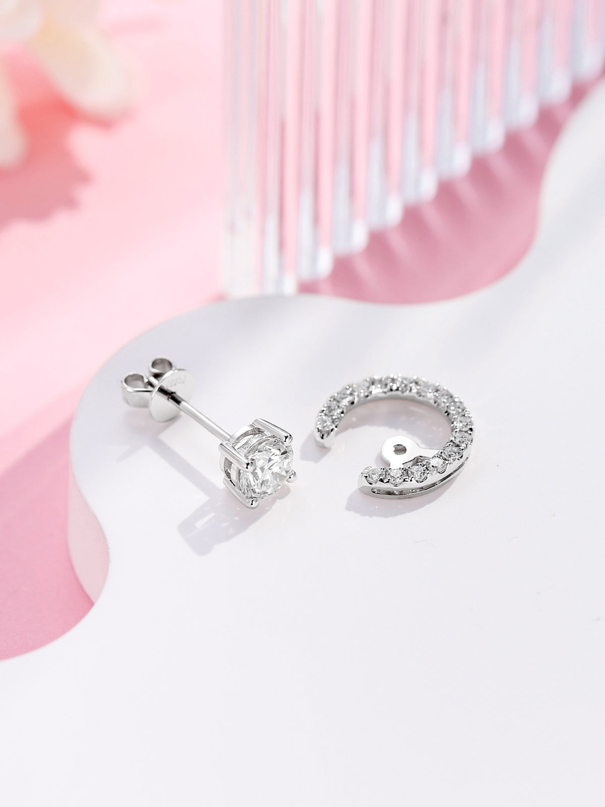 Lune solitaire diamond stud shown beside its detachable pavé crescent jacket