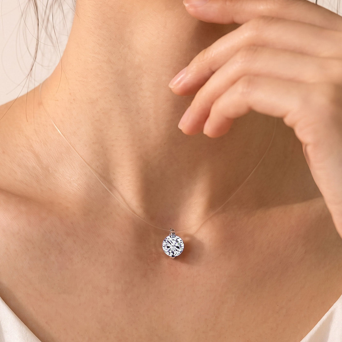 DANFÉE Mermaid's Tear diamond necklace worn on an invisible clear line
