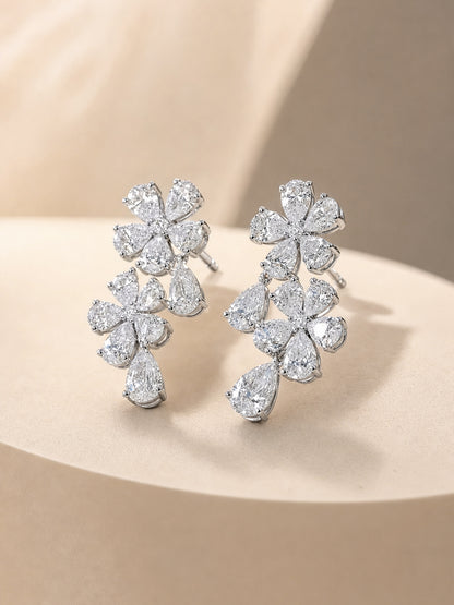 Side view of 14K white gold pear diamond flower earrings showing claw settings and push-back posts