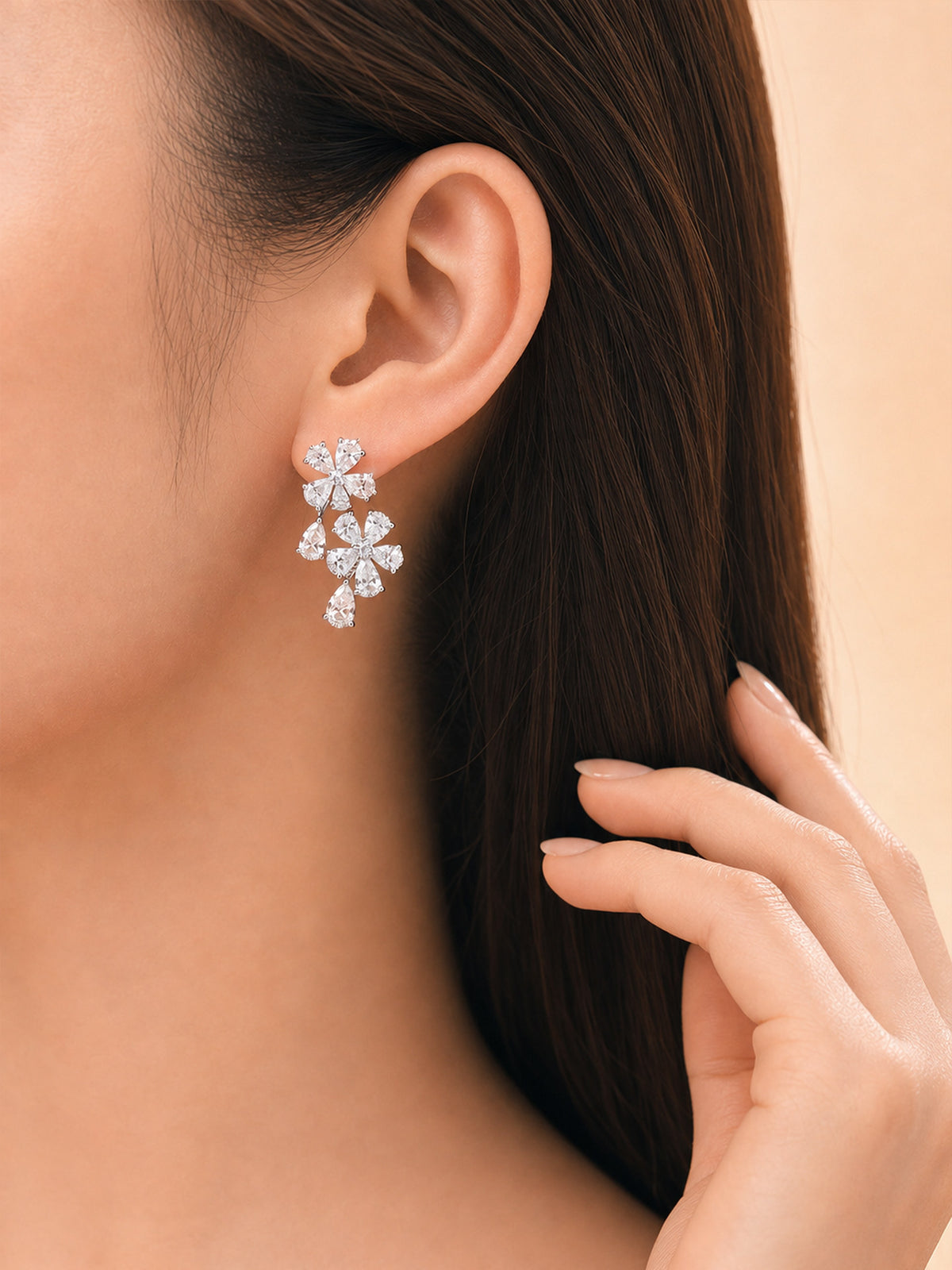 Model wearing the pear-cut lab-grown diamond flower cluster earring in 14K white gold