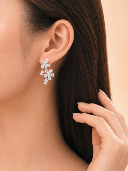 Model wearing the pear-cut lab-grown diamond flower cluster earring in 14K white gold