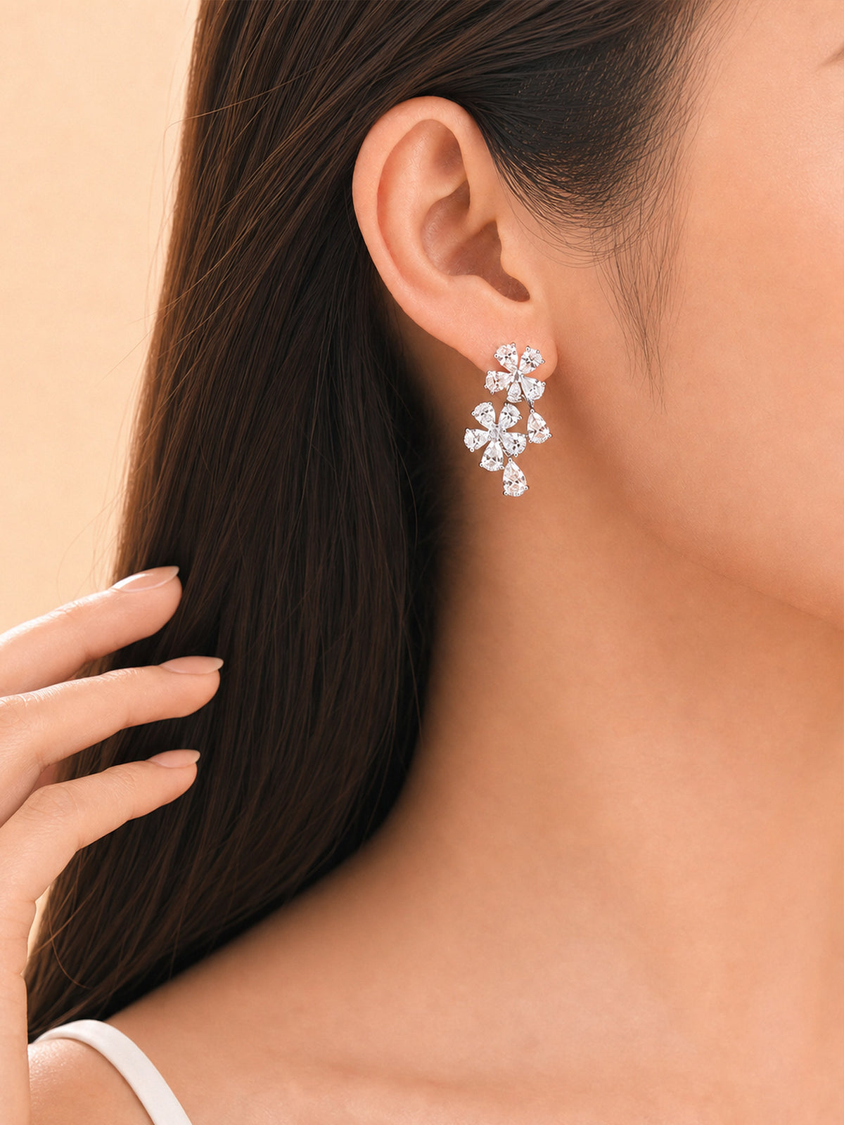 Forget-me-not diamond drop earring worn on the ear for a wedding or evening look