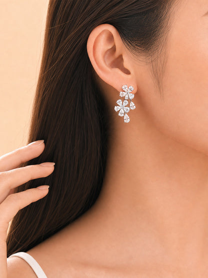 Forget-me-not diamond drop earring worn on the ear for a wedding or evening look
