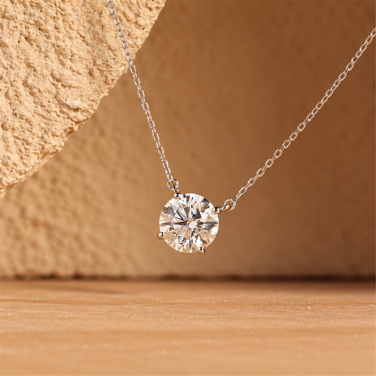 18K white gold four-prong diamond necklace against warm natural stone