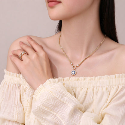 DANFÉE octagon halo diamond necklace worn with an off-shoulder ivory top