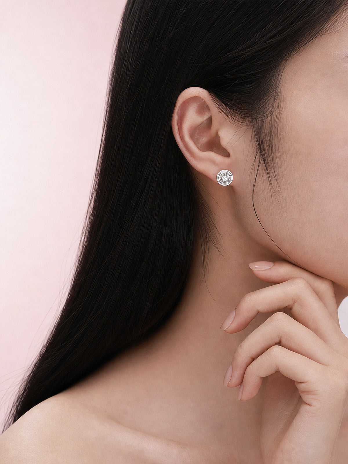 18K white gold tiered bezel diamond stud worn on the ear