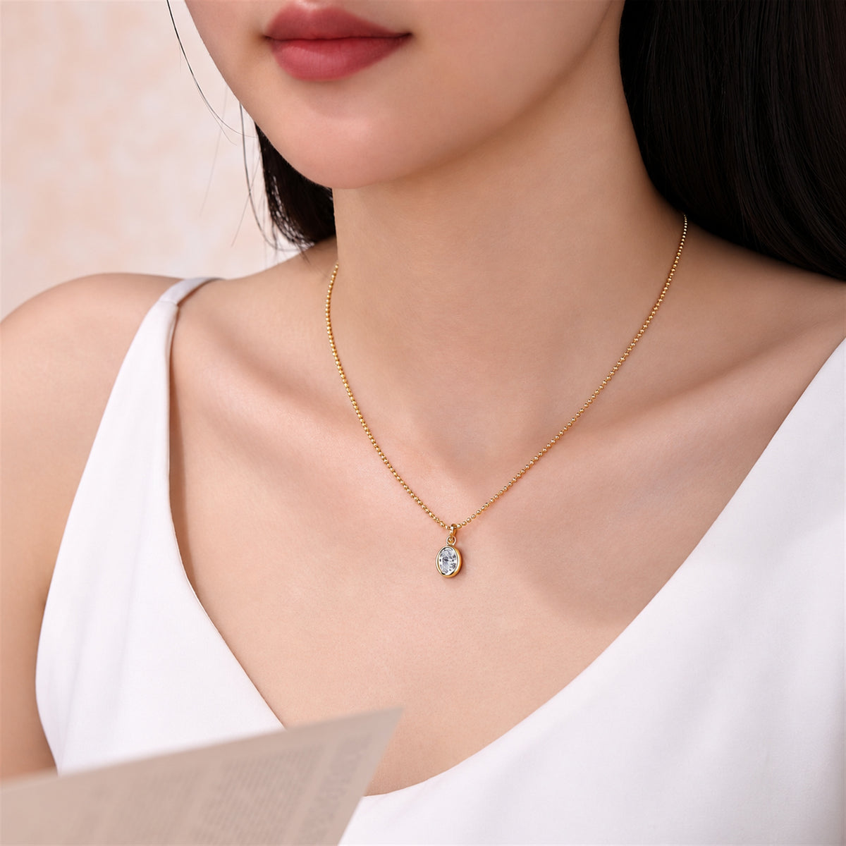 DANFÉE oval bezel lab-grown diamond necklace in 18K yellow gold worn with a white top