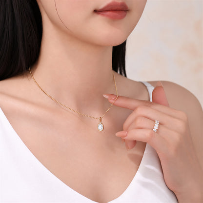 DANFÉE oval bezel lab-grown diamond necklace in 18K yellow gold worn with a white top