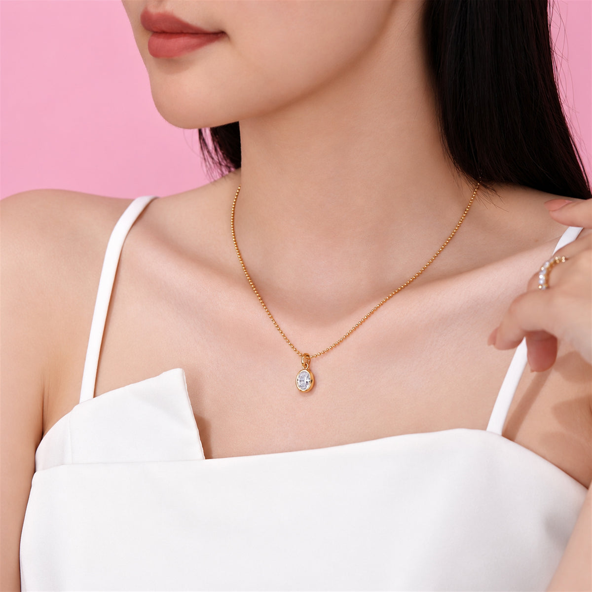 DANFÉE oval bezel lab-grown diamond necklace in 18K yellow gold worn with a white top