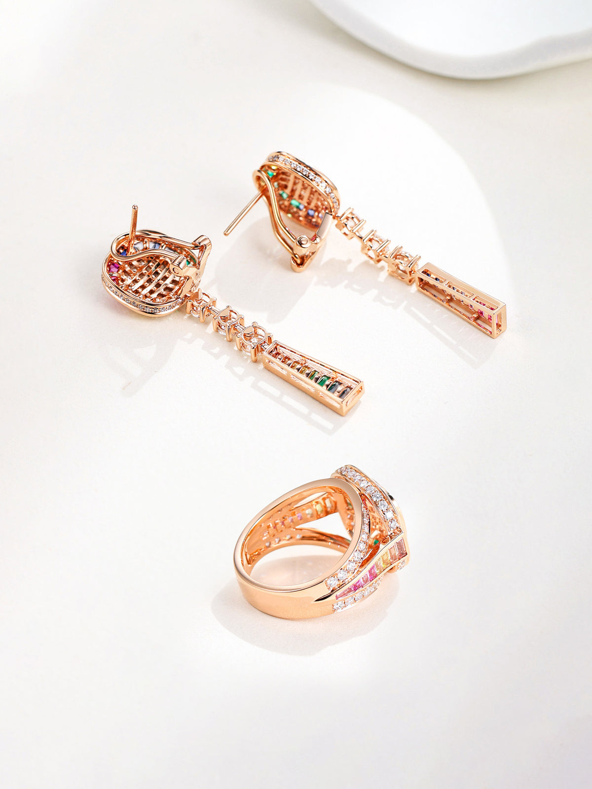 Back of the 18K gold drop earrings showing the omega clip and pavé-set gallery