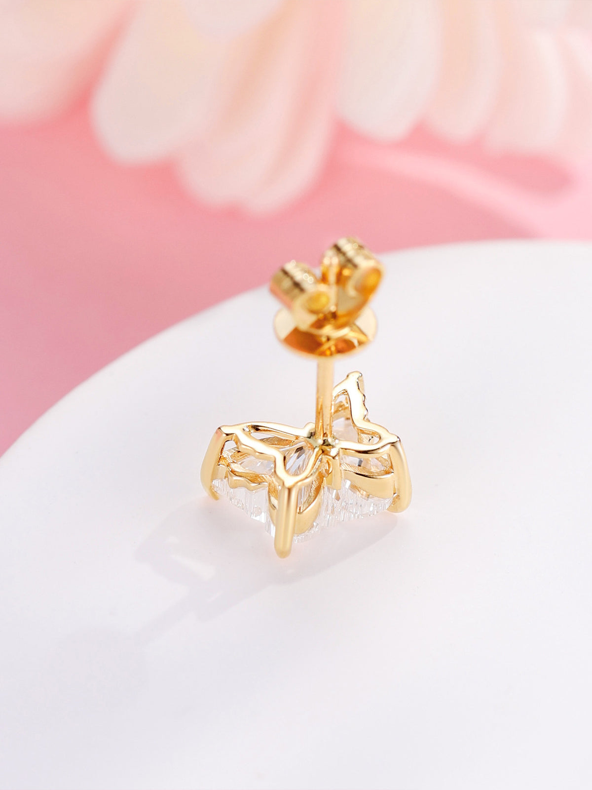 Back of 18K gold butterfly diamond stud showing the open butterfly gallery and four claws