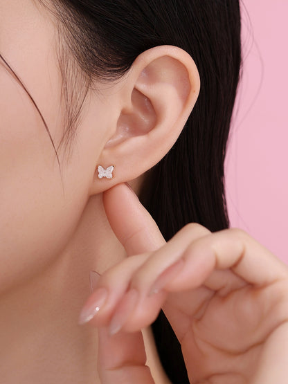 Model wearing an 18K gold butterfly diamond stud earring, side view