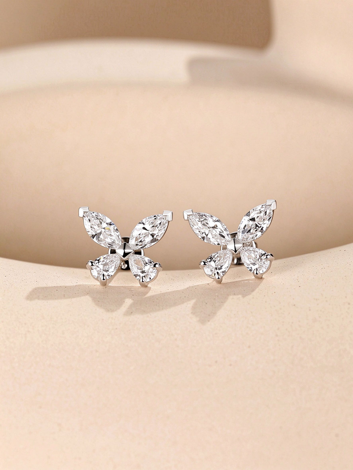Pair of PT950 platinum butterfly diamond stud earrings, front view