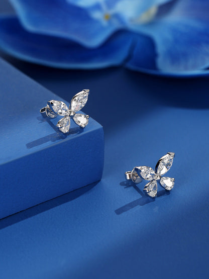 Butterfly lab-grown diamond stud earrings on a sapphire-blue stand