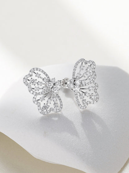 Papillon openwork butterfly diamond earrings resting on white stone